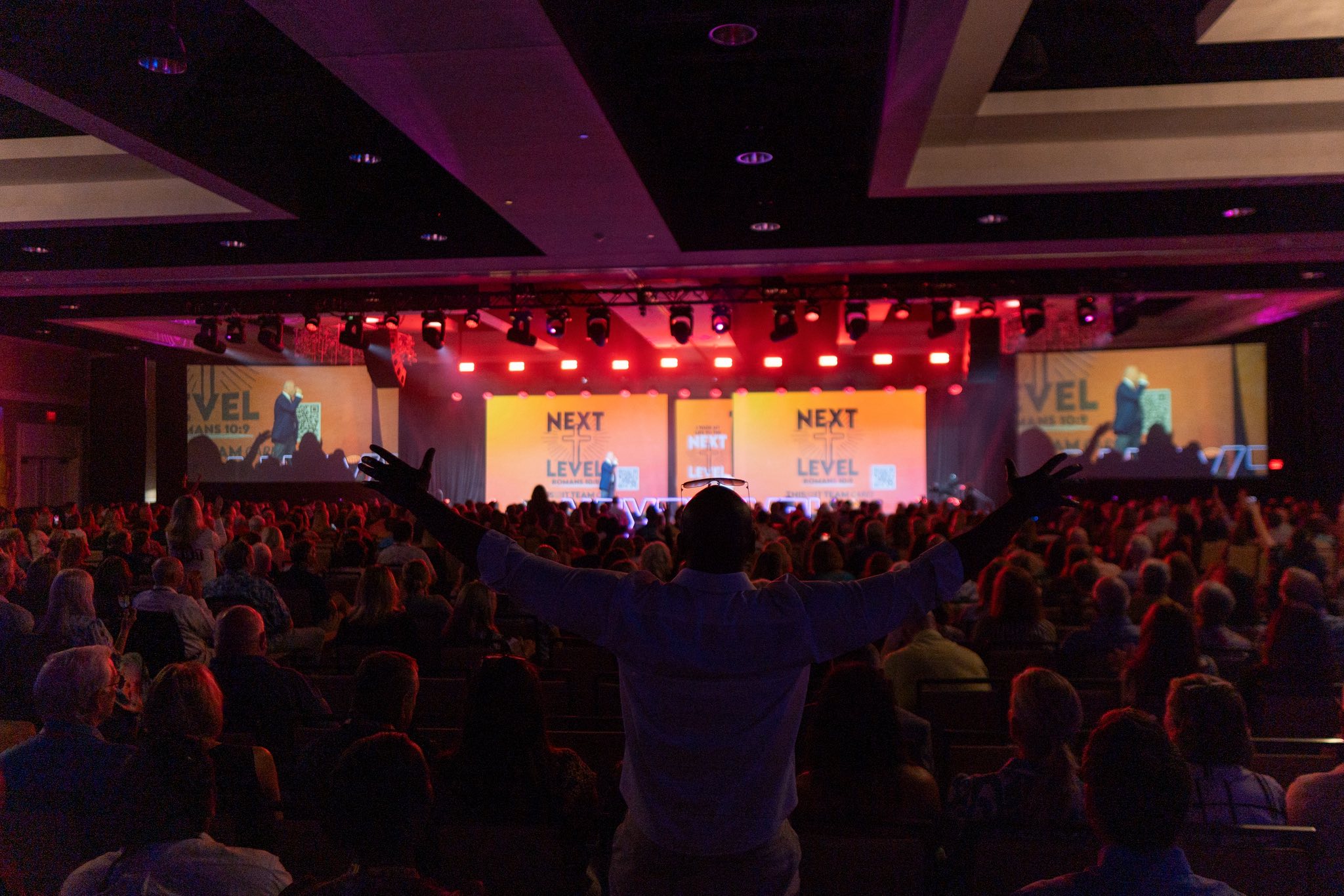 Audience attending a corporate event with live stage presentation
