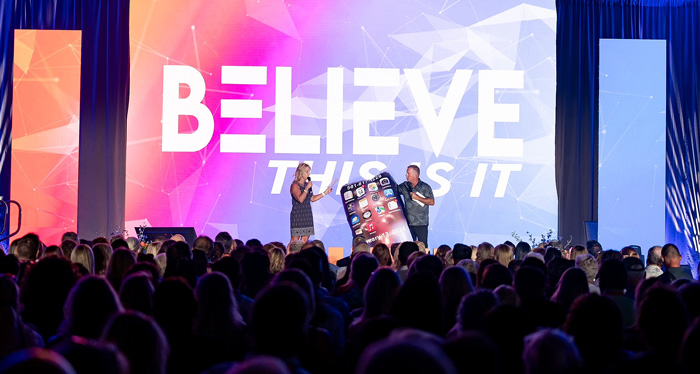Audience watching a live corporate event presentation on stage